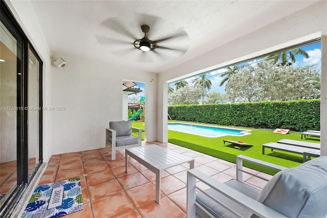 view of patio featuring a fenced in pool and ceiling fan