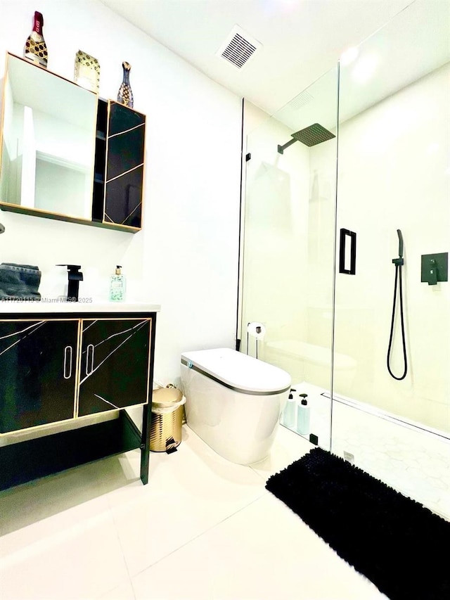 bathroom with tile patterned floors, vanity, an enclosed shower, and toilet