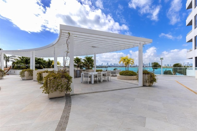 view of patio featuring a water view and a pergola