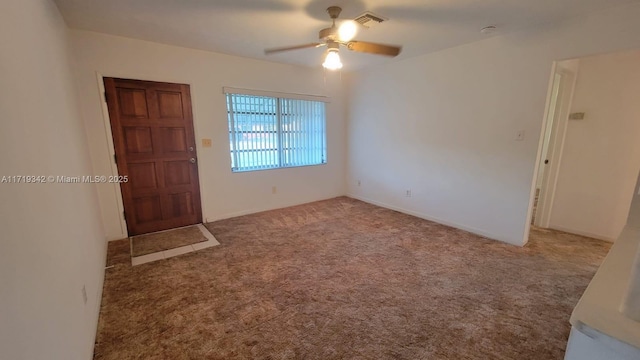 empty room featuring ceiling fan and carpet floors