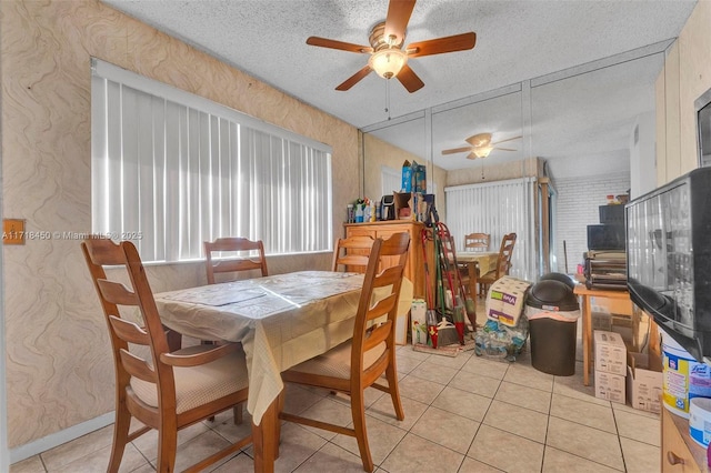 tiled dining area featuring a textured ceiling and ceiling fan