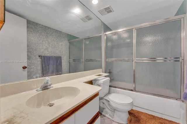 full bathroom with vanity, bath / shower combo with glass door, and toilet