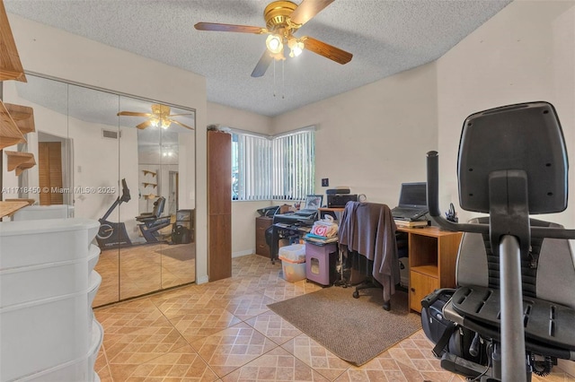 office with ceiling fan, light tile patterned flooring, and a textured ceiling