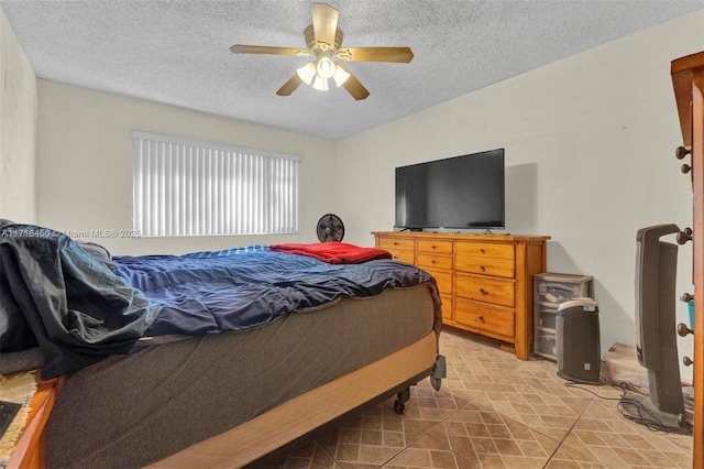 bedroom with a textured ceiling and ceiling fan