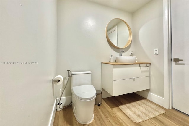 bathroom featuring hardwood / wood-style flooring, vanity, and toilet
