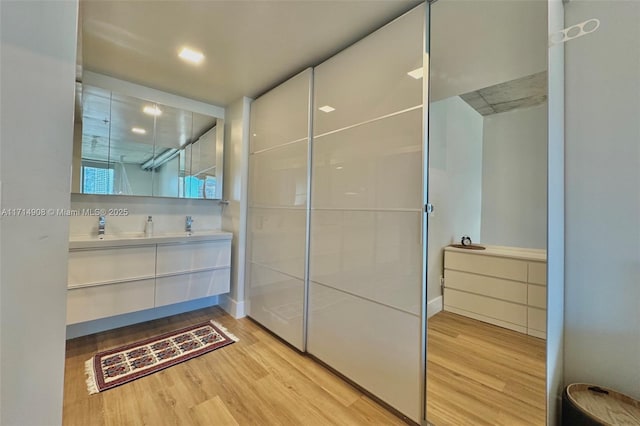 bathroom with hardwood / wood-style floors and vanity