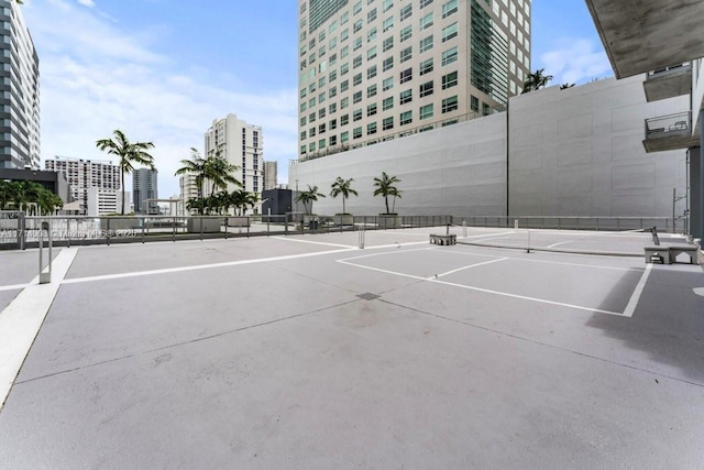 view of tennis court featuring basketball hoop