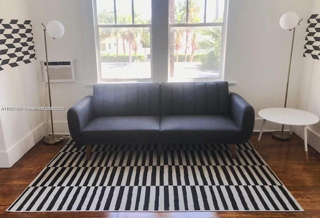 living room with a wall mounted air conditioner and dark hardwood / wood-style floors