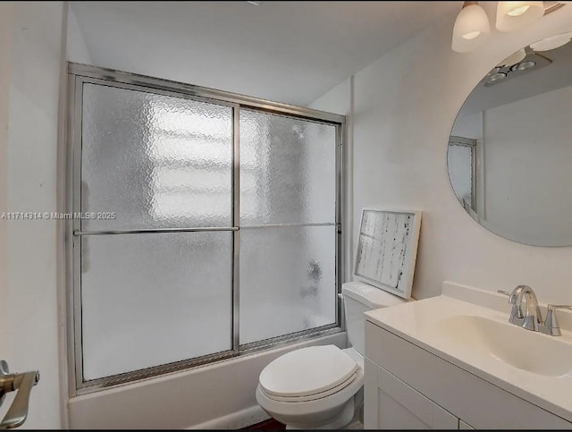 full bathroom with vanity, toilet, and shower / bath combination with glass door