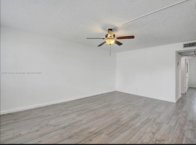 unfurnished room with a textured ceiling, light wood-type flooring, and ceiling fan