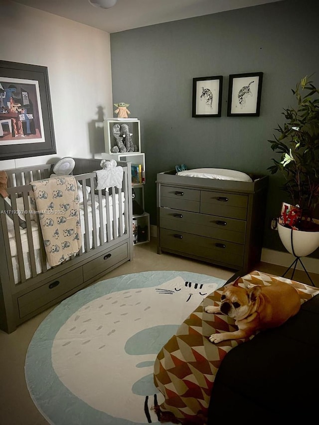 bedroom featuring a nursery area