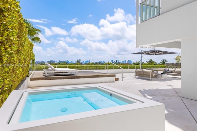 view of pool featuring a patio area, an in ground hot tub, and an outdoor hangout area