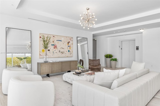 living room with a tray ceiling, elevator, and a chandelier