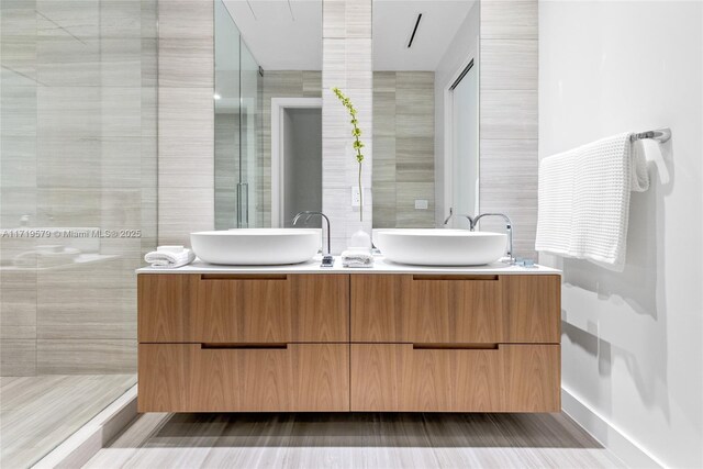 bathroom with a shower and vanity