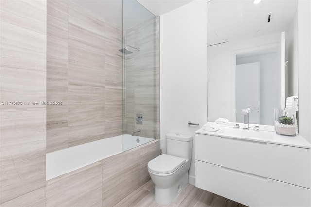 full bathroom with vanity, toilet, and tiled shower / bath