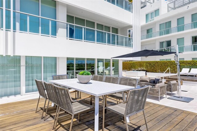 wooden terrace with an outdoor living space