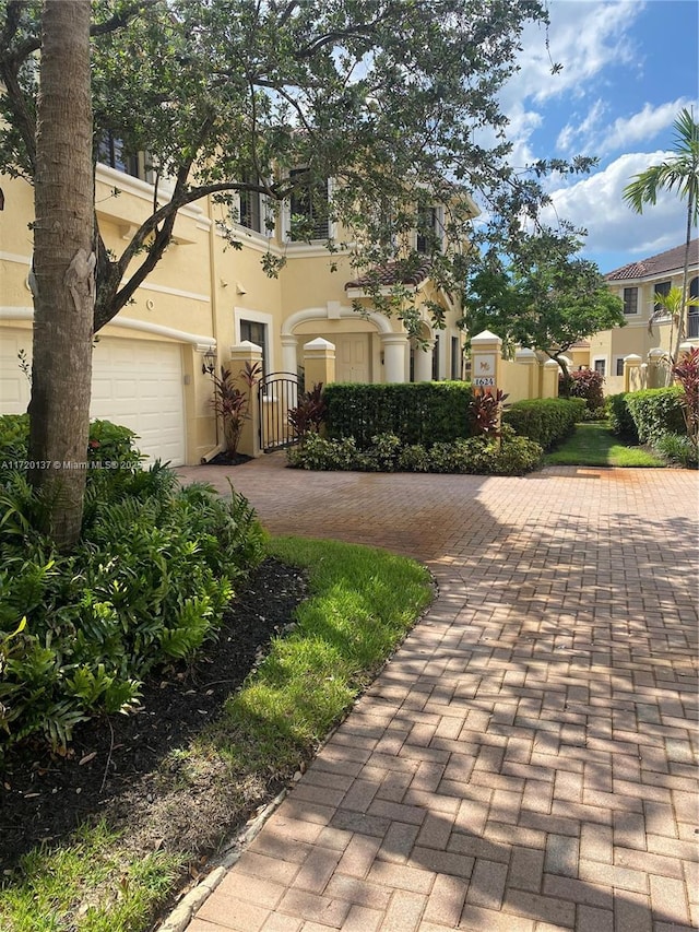 mediterranean / spanish-style home with a garage