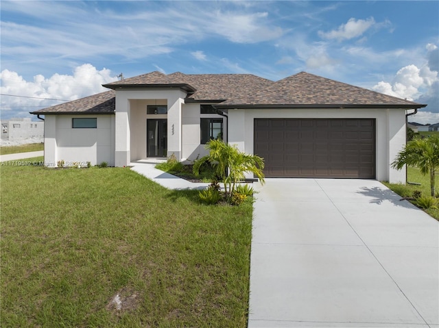 view of front of house featuring a front yard and a garage