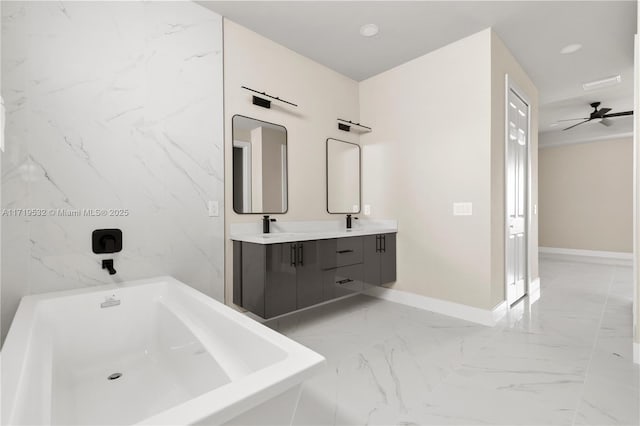 bathroom featuring ceiling fan, a tub to relax in, and vanity