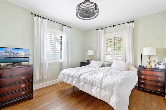 bedroom featuring hardwood / wood-style flooring and multiple windows