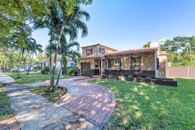 mediterranean / spanish-style home with a front lawn and a garage