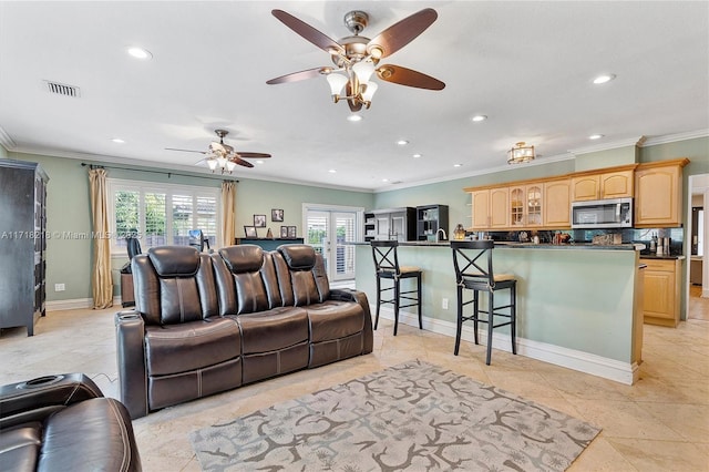 tiled living room featuring ceiling fan and ornamental molding