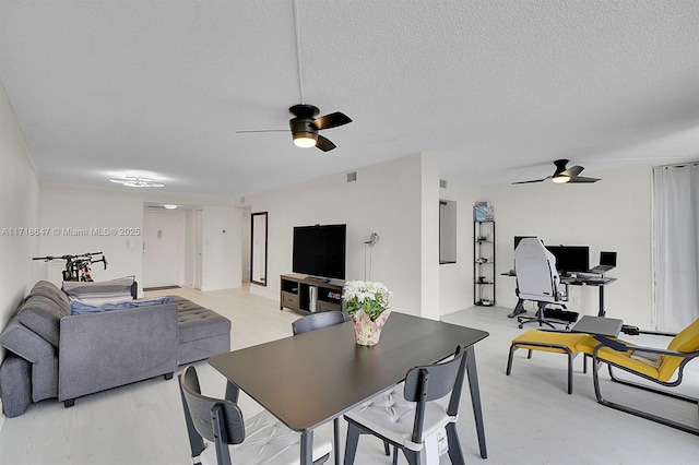 800 Parkview Dr Unit 1001, Hallandale Beach, FL 33009 - living area featuring ceiling fan, a textured ceiling, a desk, and light wood finished floors