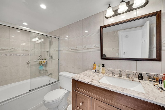 800 Parkview Dr Unit 1001, Hallandale Beach, FL 33009 - bathroom with tile walls, toilet, vanity, and combined bath / shower with glass door