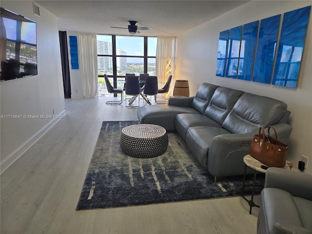 800 Parkview Dr Unit 1001, Hallandale Beach, FL 33009 - living room featuring wood finished floors, expansive windows, a ceiling fan, and baseboards