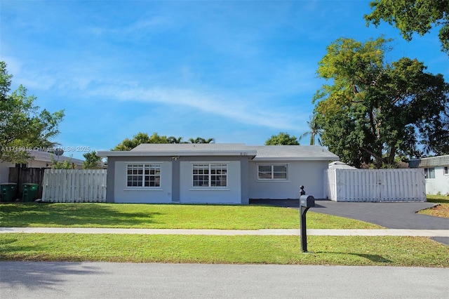 ranch-style home with a front lawn