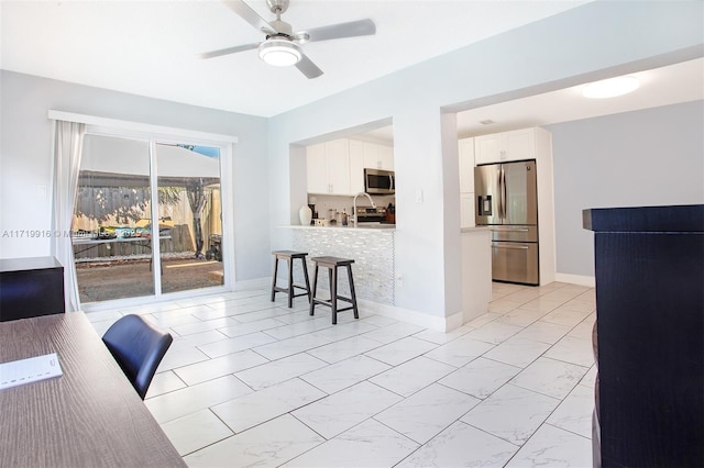 interior space featuring ceiling fan and sink