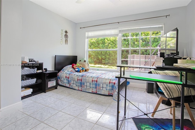 bedroom featuring ceiling fan and light tile patterned floors