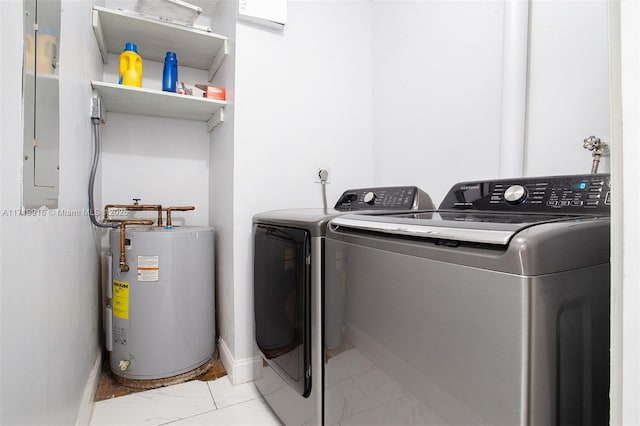 clothes washing area with separate washer and dryer and water heater