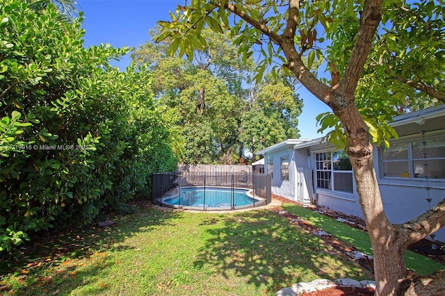 view of pool with a yard