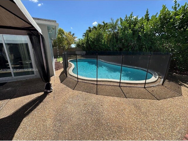 view of patio featuring a fenced in pool and a gazebo