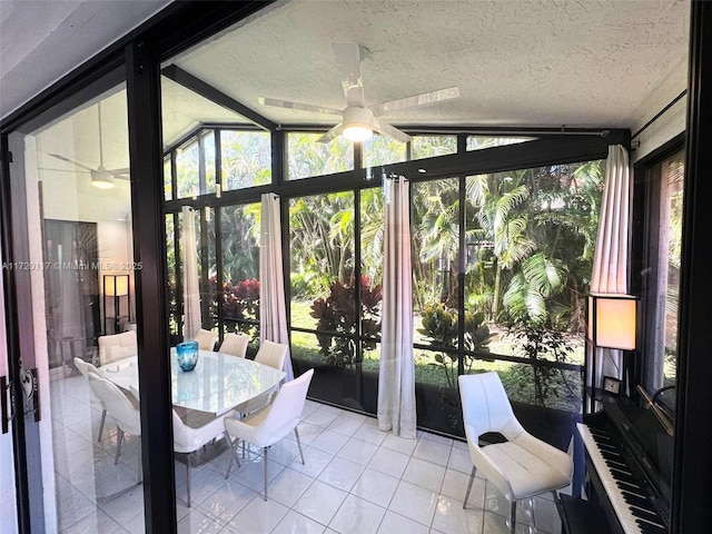 sunroom featuring ceiling fan and lofted ceiling