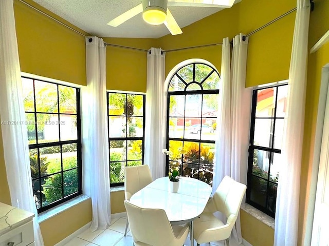 sunroom / solarium featuring ceiling fan