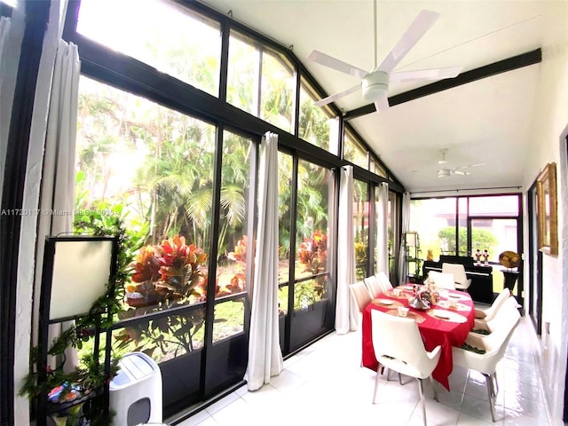 sunroom featuring ceiling fan, a healthy amount of sunlight, and vaulted ceiling