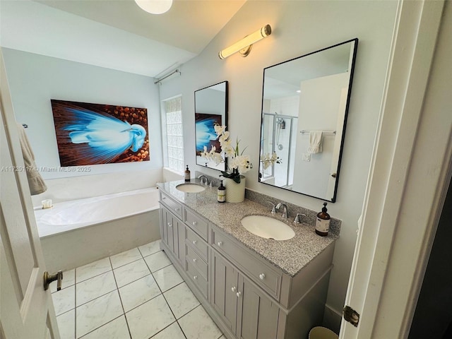 bathroom featuring shower with separate bathtub, vanity, lofted ceiling, and tile patterned flooring