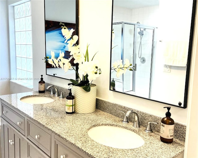 bathroom with vanity and a shower with door