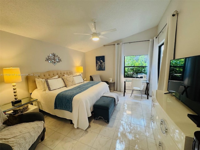 bedroom with vaulted ceiling, ceiling fan, and a textured ceiling