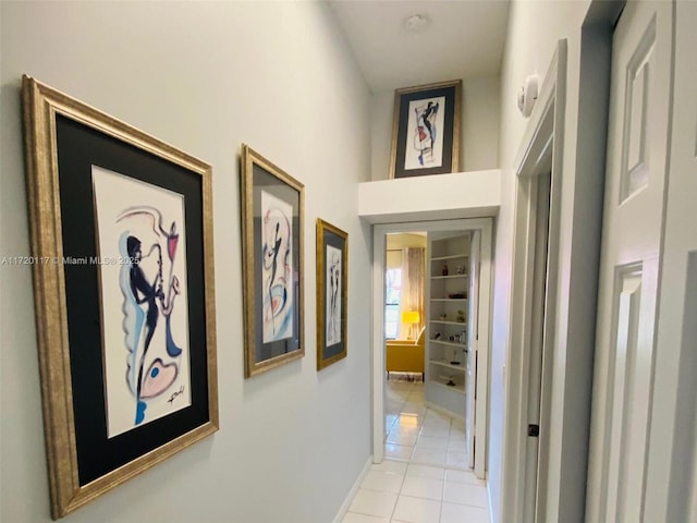 hallway with light tile patterned floors and built in features