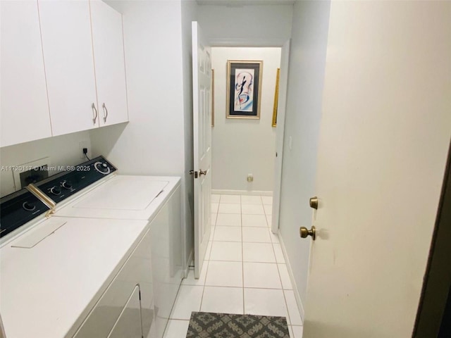 laundry room with cabinets, light tile patterned floors, and independent washer and dryer