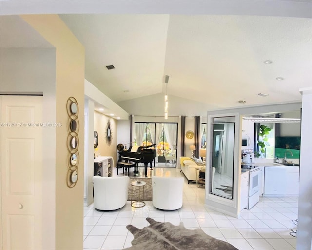 tiled living room featuring vaulted ceiling and a healthy amount of sunlight