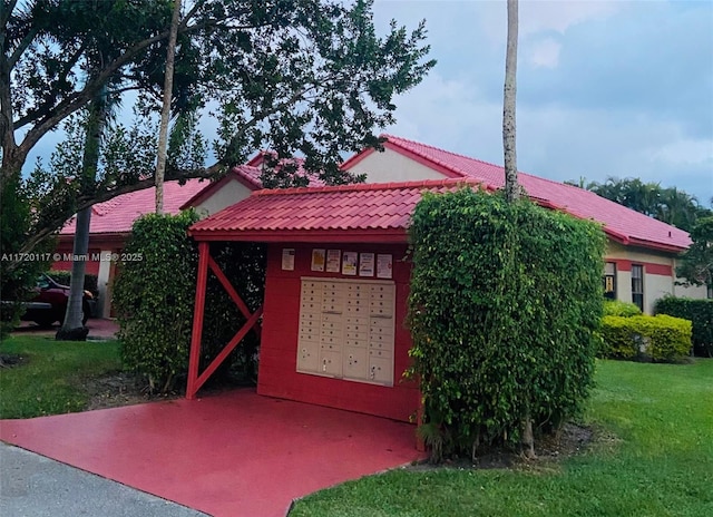 view of side of property featuring mail boxes