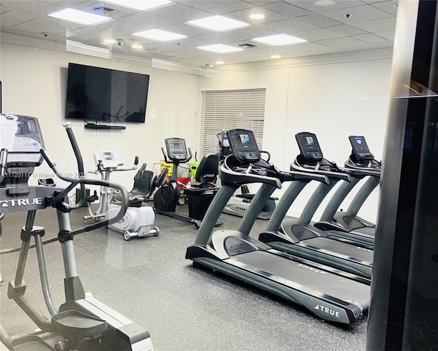 workout area featuring a drop ceiling, visible vents, and crown molding