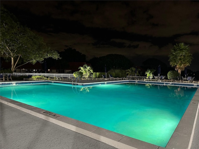 view of pool at night