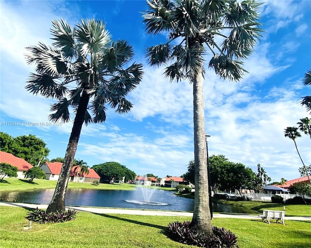 surrounding community featuring a yard and a water view