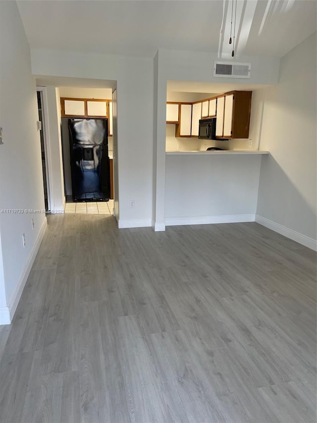 unfurnished living room featuring light wood-type flooring