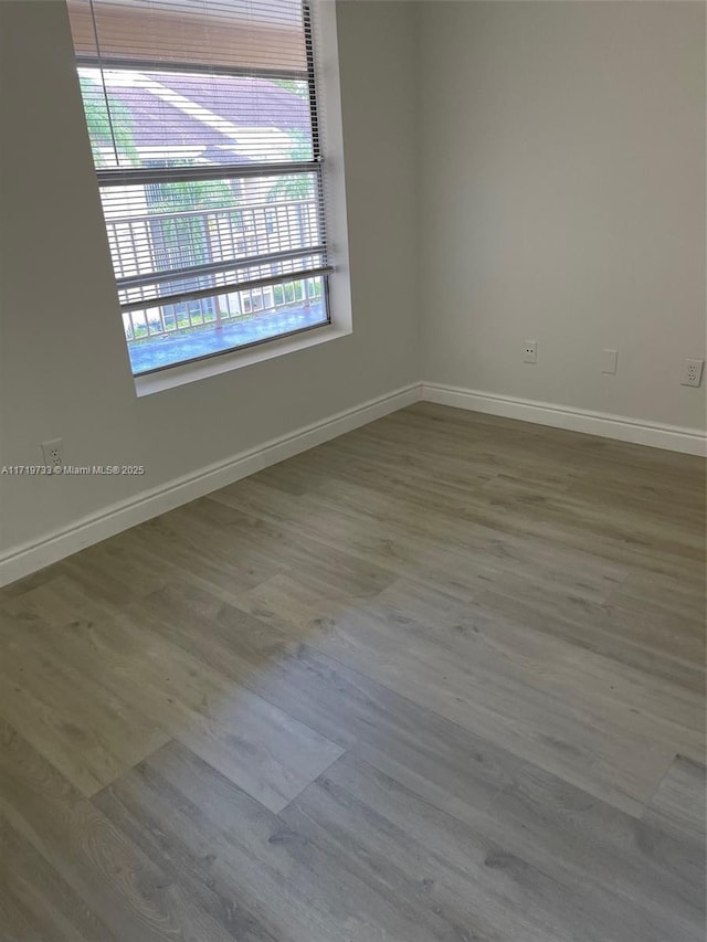 spare room featuring hardwood / wood-style flooring